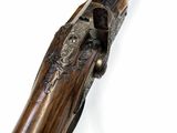 an old gun with a wooden handle on a white background