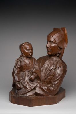 a statue of a woman holding a child on top of a wooden base