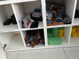 a white shelf filled with lots of different types of shoes