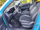 the interior of a blue car with the driver ' s seat up