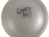 an image of a white glass ball with a sticker on it