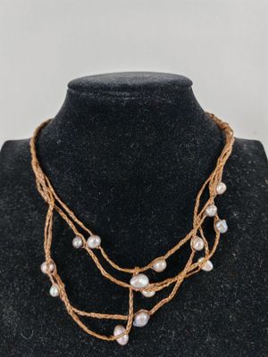 a close up of a necklace on a mannequin mannequin