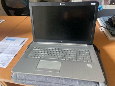 a laptop computer sitting on top of a wooden desk