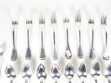 a lot of silver spoons and forks on the table