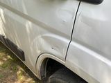 a white van that is parked on the side of the road