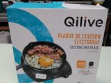 the box of the electric skillet is sitting on the table