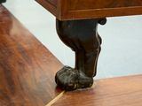 a close up of a wooden bench with a foot on it