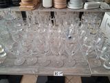 many empty wine glasses sitting on a table in a store