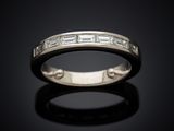 a close up of a wedding ring on a black surface