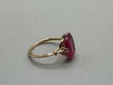 an image of a gold ring with a pink stone
