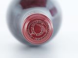 a close up of a wine bottle with a red label