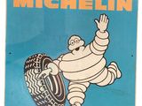 an old michel michel tire sign is hanging on a wall