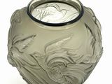 a glass vase with a design on it on a white surface