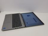 a laptop computer sitting on a table with a tablet on top of it