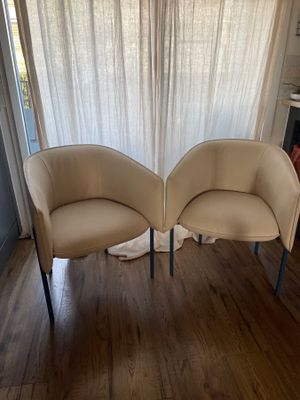two chairs sitting next to each other on a hard wood floor