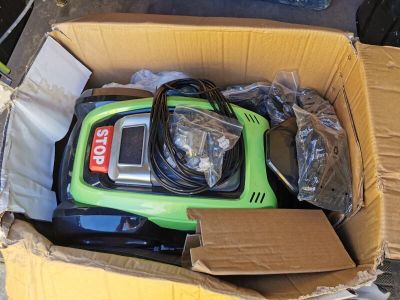 a box with a green and black vacuum in it