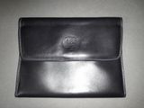 black leather wallet with a lion emblem on the front