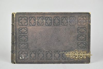 un vieux livre posé sur une table blanche à côté d'un mur blanc