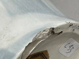 a close up of a broken toilet with a sticker on it