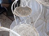 three chairs and a table that are sitting on the ground