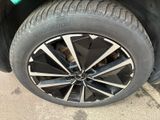 the tire of a black car with a green sticker on it