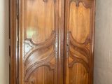 a large wooden cabinet with a mirror on top of it