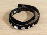 a black leather bracelet with crystal stones on it
