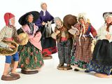 five figurines of people dressed in traditional clothing