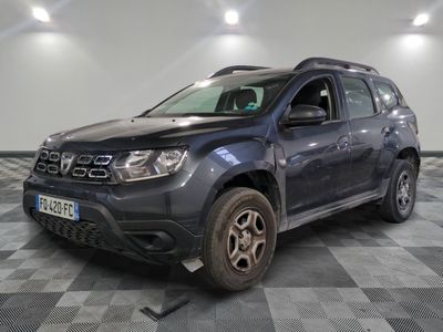 the front view of a grey dacia parked on a checkered floor