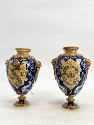 two vases that are sitting on a white surface