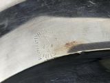 a close up of a metal object with a black stripe