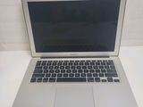 a silver laptop computer sitting on a white table
