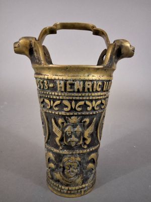 an old brass vase with a handle on a white background