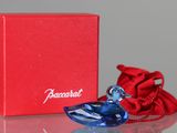 the small blue glass bird is next to a red box
