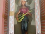 doll in a pink box with a guitar in it and a pink box with a picture of a woman in a pink shirt