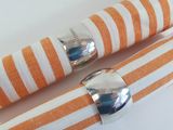 orange and white striped napkins with silver napkin rings on them