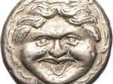 a silver coin with a smiling face on it