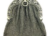 a silver metal purse with a chain handle