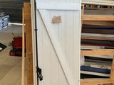 a wooden pallet with a white door on top of it