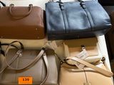 many different purses on a table in a store