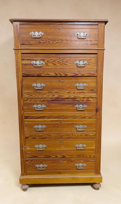 a wooden chest of drawers with four drawers on each side