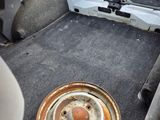 a car with a flat tire in the back of the car