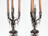 paire de bougeoirs anciens en bronze ornés de têtes de cerfs, posés sur un socle en marbre
