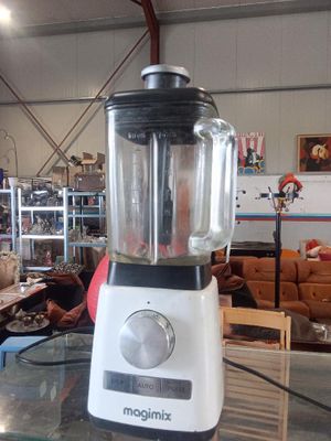 a blender sitting on a glass table in a room