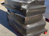 a stack of black plastic bags sitting on a pallet