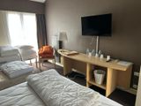 two beds in a hotel room with a flat screen tv on the wall