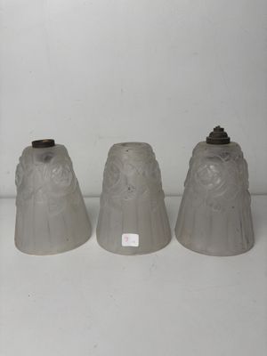 three gray vases sitting on top of a white shelf next to each other