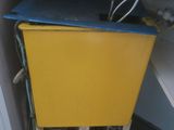 a yellow cabinet with a blue top in the corner of a room