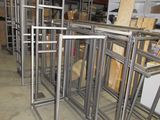 many metal frames stacked on top of each other in a warehouse