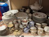 many plates and bowls on a table in a room